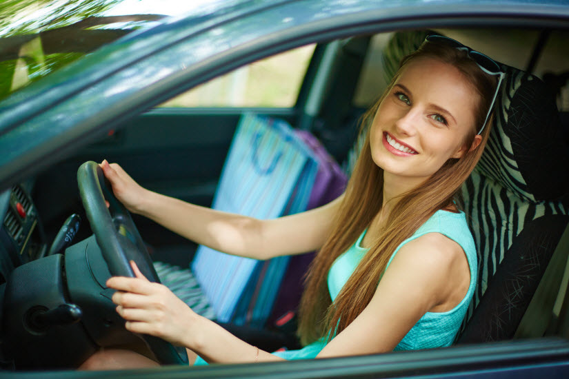 Woman taking test drive of a car with smile